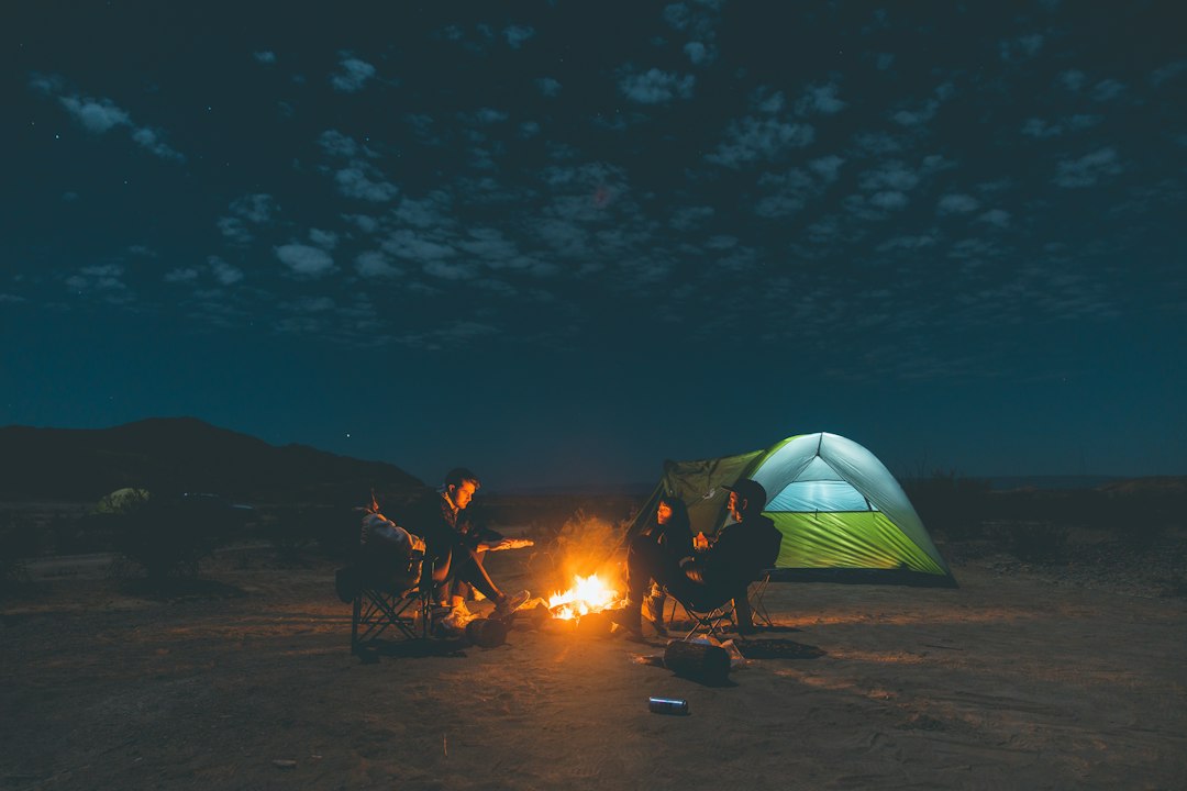 people-sitting-on-camping-chairs-near-bonfire-during-night-time-ezitbykgdss